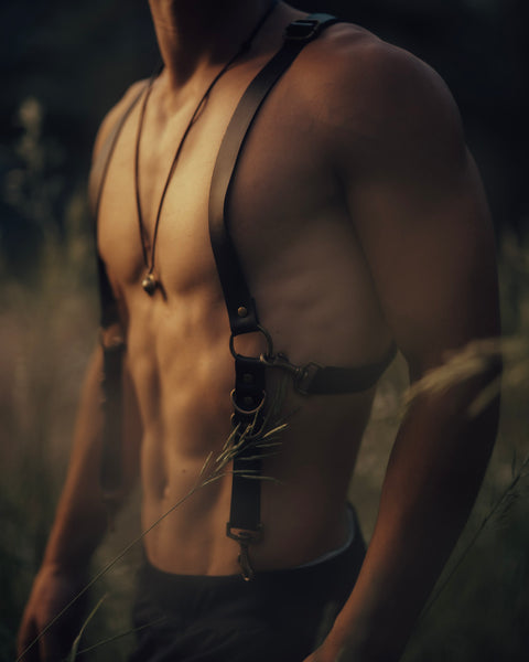 Man wearing Bijou by Juju black leather suspenders with brass hardware — handmade in Ecuador, festival-inspired, adjustable, and built for versatile styling.