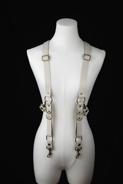 Handmade off-white leather suspenders for men or women, brass clip hardware, product photo on mannequin.
