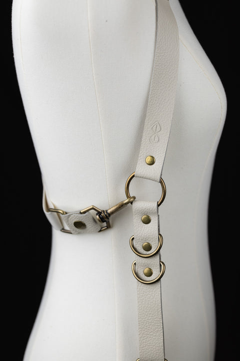 off-white leather suspenders with brass hardware for a rugged, grounded look