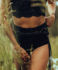 woman in natural setting in Bijou by juju Bohemian leather fringe belt layered over everyday basics