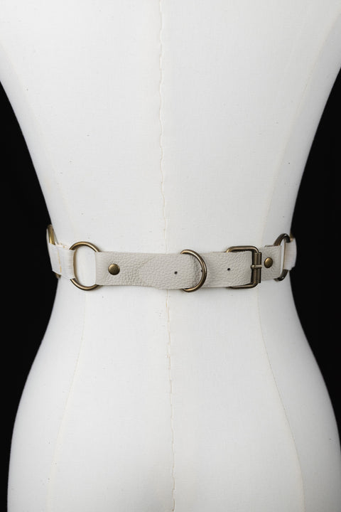 off white corset close up of brass buckle 
