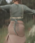 woman in bijou by juju's off white corset dancing in a field 