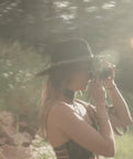 Juju, Founder of Bijou by Juju, in a field taking photos of Bijou by Juju