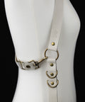 off-white leather suspenders with brass hardware for a rugged, grounded look